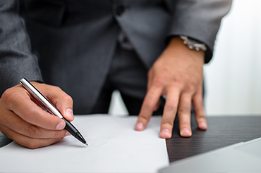 divorce attorney near syracuse ny image of person signing paper for spousal maintenance from karp law office